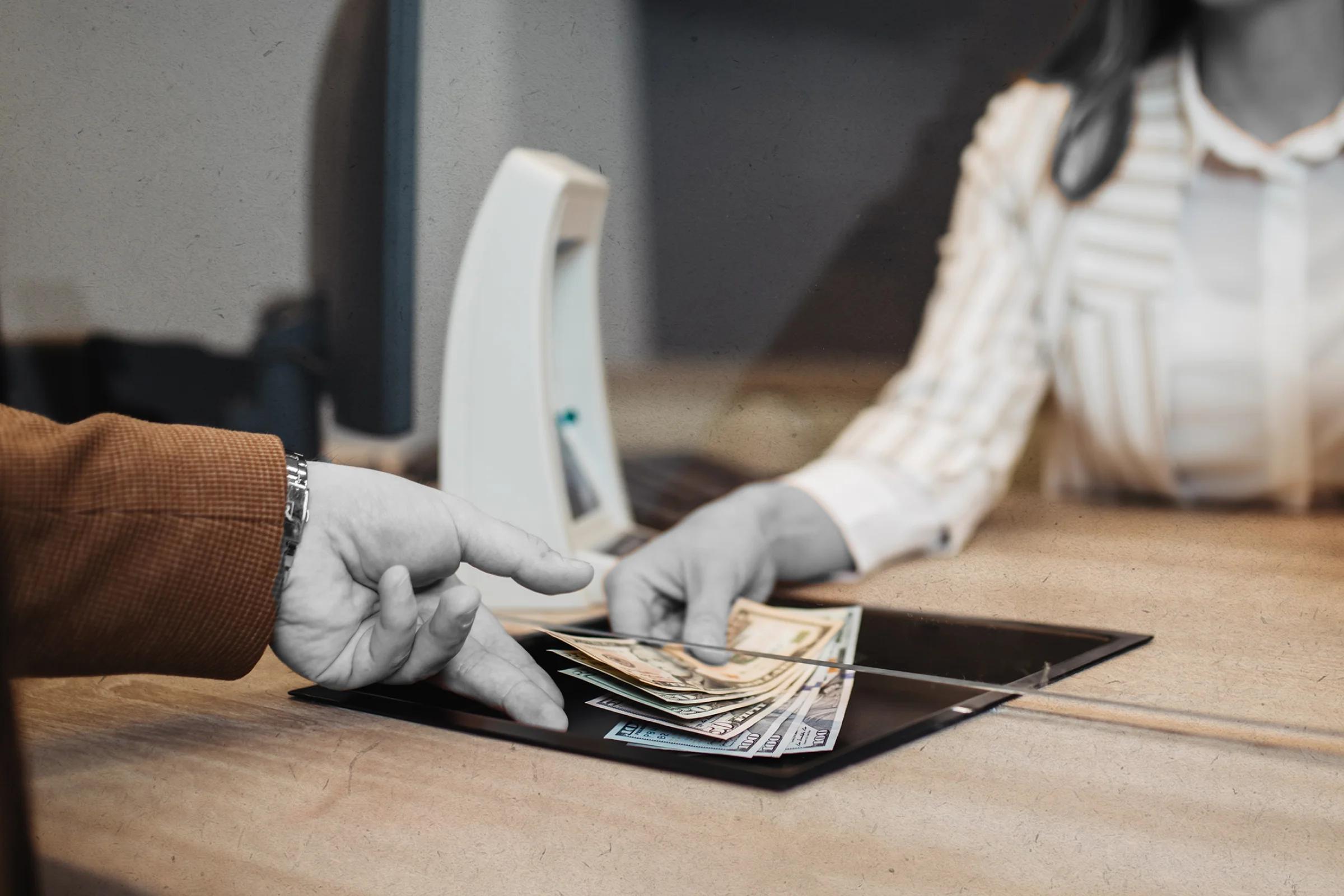 Illustration of bank teller handing money to customer