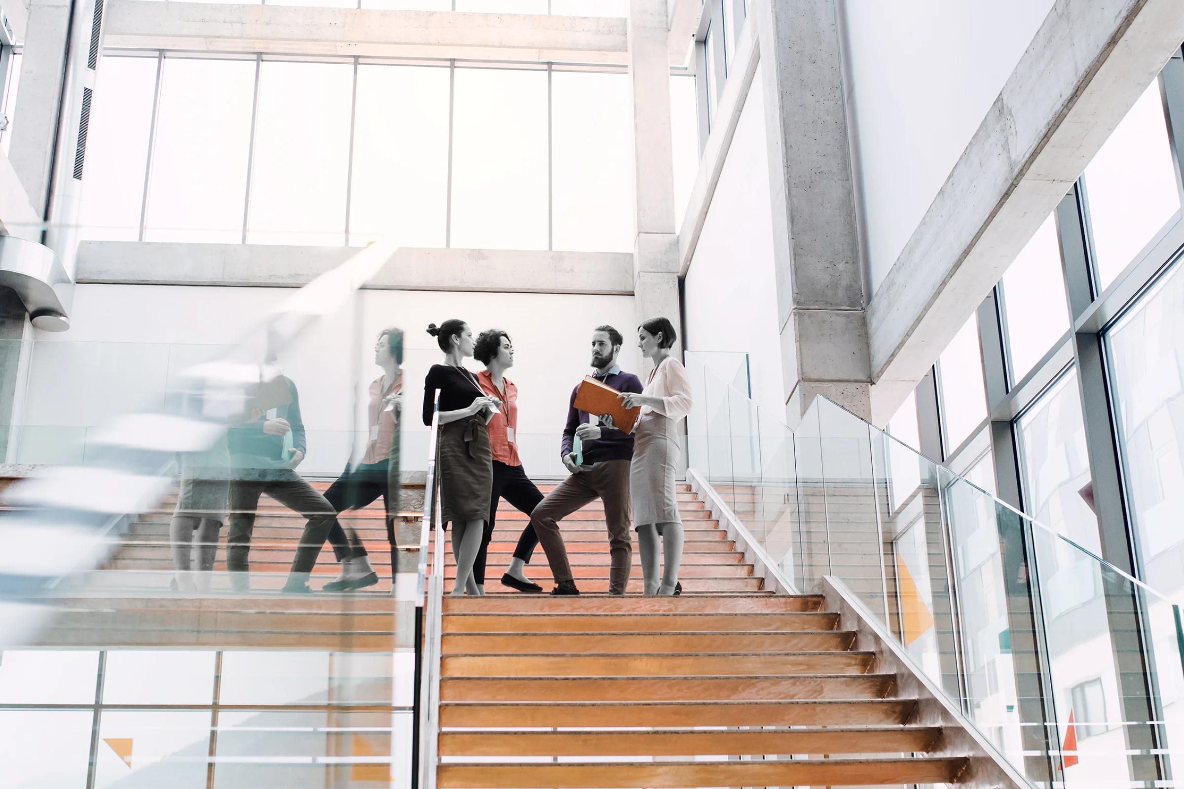 image of workers talking on stairs in an office